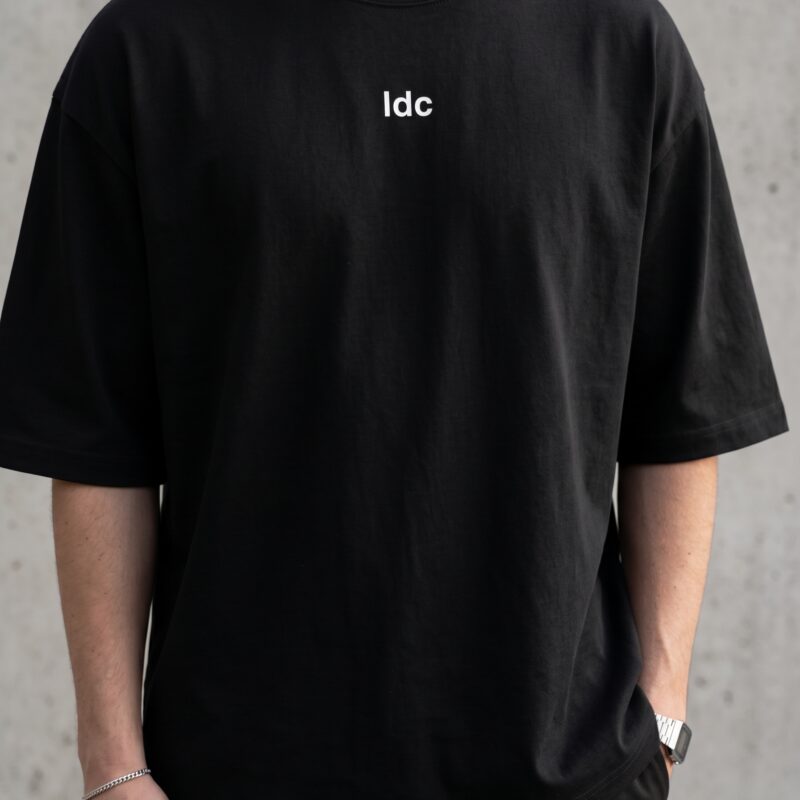 MDFKR oversized black heavyweight t-shirt with minimalist IDC chest logo front view