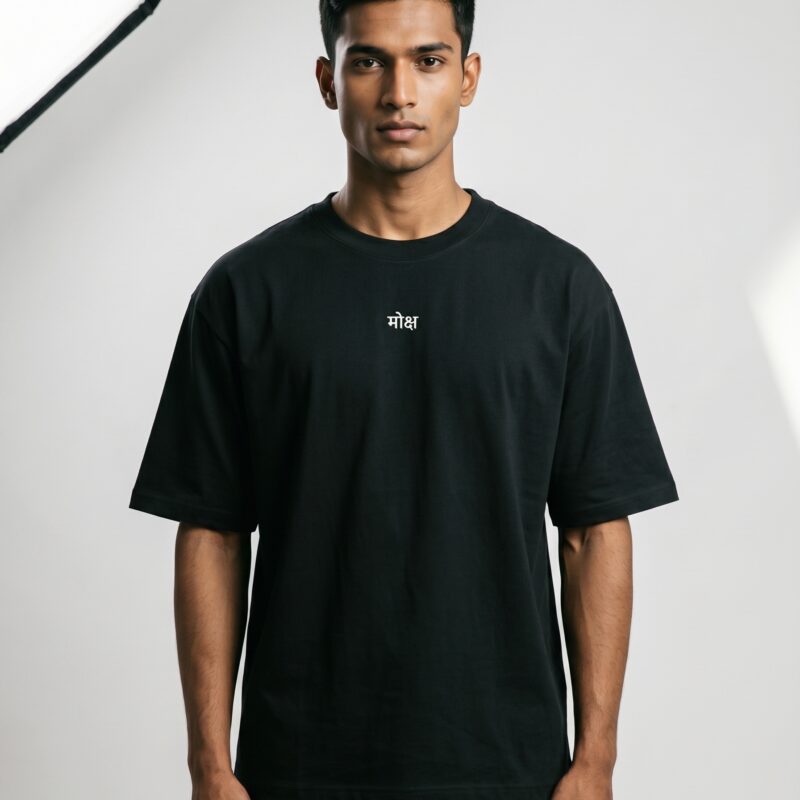 Front view of a male model wearing the Moksha oversized black heavyweight T-shirt featuring a minimal Devanagari chest print and relaxed streetwear fit.